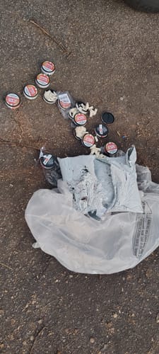 Customer's damaged shipment of Chewy Watermelon, with cans and pouches spilled from torn packaging onto the ground.