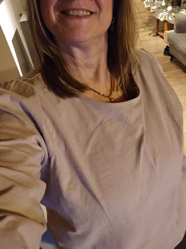 Cliente portant la blouse Amarante en velours sable, montrant la coupe ample et le col rond.