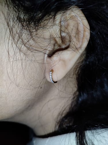 Reviewer's close-up of the Gold Glowing Sphere Diamond Hoop Earring being worn.