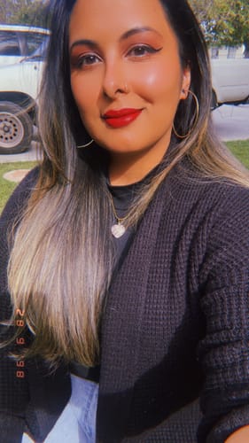 Customer wearing a lovely gold necklace with a pink heart-shaped crystal from the VIP Crystal Club.