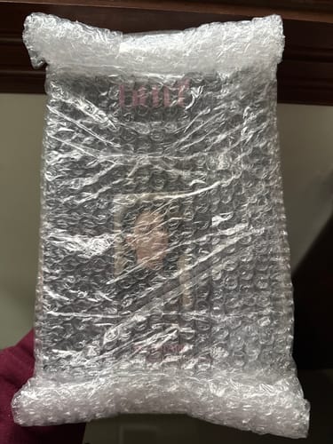 Reviewer holding the Stray Kids tape album, which arrived carefully packaged in bubble wrap.