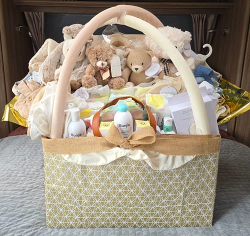 Customer's large gift basket overflowing with Probiotic Eco Nappies products, teddy bears, and baby clothes.
