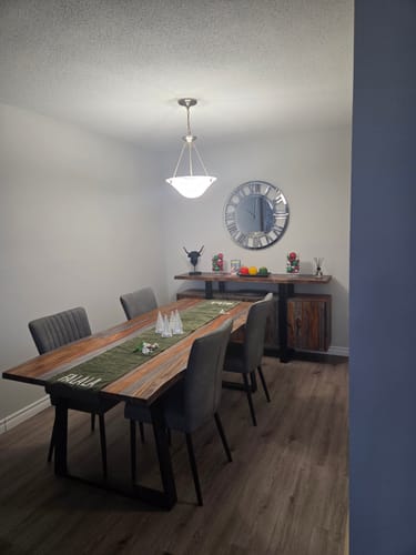 Customer's large glass mirrored clock hanging on a dining room wall above a sideboard.