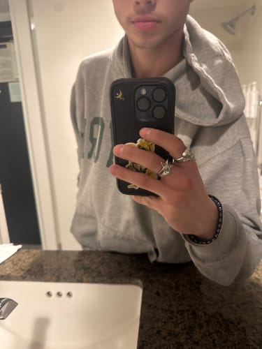 Reviewer taking a mirror selfie, showing off their silver-colored Star Ring on their finger.