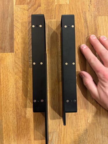 Reviewer shows the two separate black metal parts of the Weekly AM-PM Vitamin Case, with a hand for scale.