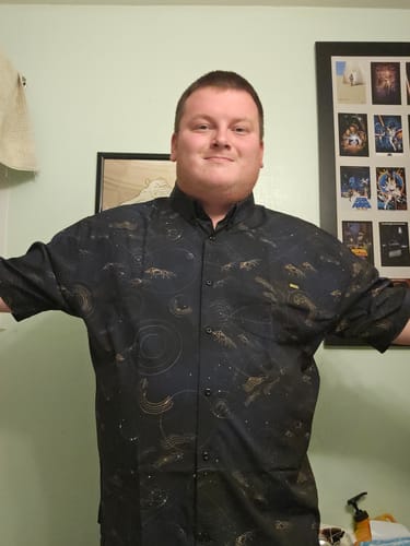 Reviewer wearing the black Star Wars™ "Purrgil" shirt, showing its excellent fit and bold pattern.