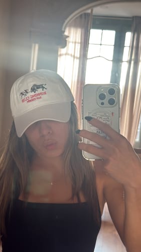 Reviewer taking a selfie while wearing the white San Fermin Dad Hat.