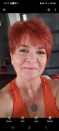 Reviewer showing her short, vibrant red hair after using the Instant Dye Shampoo.