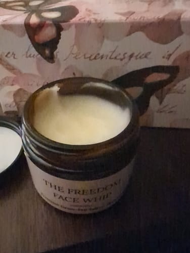 Reviewer's close-up of the open jar of The Freedom Face Whip, showing the creamy product inside.