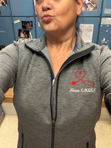 Reviewer wearing the grey Digi Stripe Personalized Nurse Full Zip, highlighting the fit and custom embroidery.