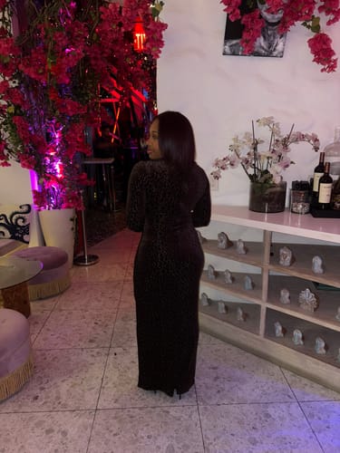 Reviewer from behind, showing the fit of the Burnout Print Turtleneck Maxi Dress.