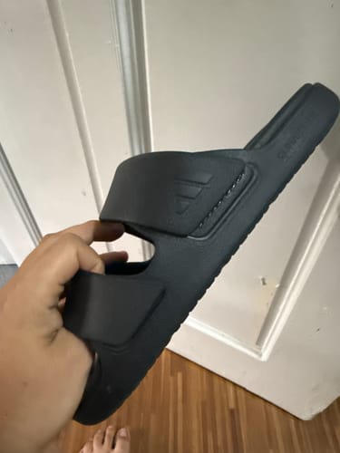 Customer holding a black adidas Znscape Sandal, showing the side profile and double straps.