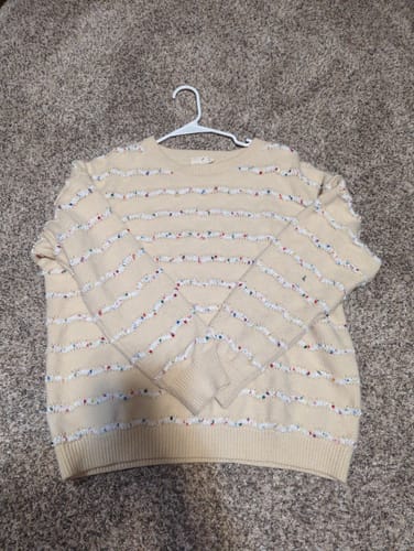 Customer's beige Cozy Cheer Sweater with textured stripes, laid flat on a hanger.