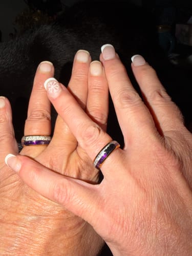 Customers wearing their beautiful Guardian 6mm commitment rings on their interlaced hands.
