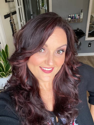 A reviewer's voluminous, dark red hair after using the Native Essence™ Shampoo Bar.