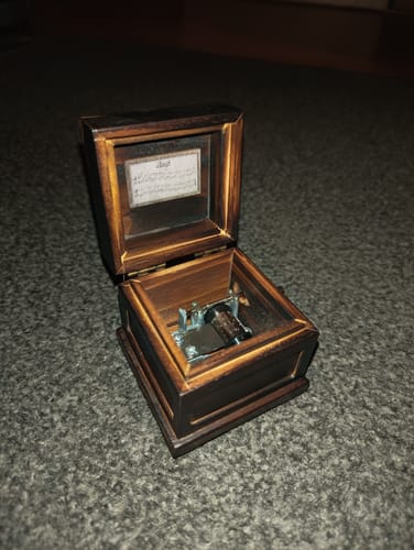 Customer's dark wood Phasmophobia Music Box is open, showing the musical mechanism inside.