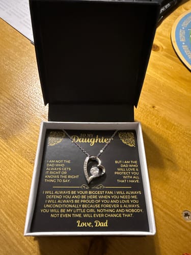 Reviewer's 'To My Daughter' gift set showing the heart necklace and message card inside its open black box.