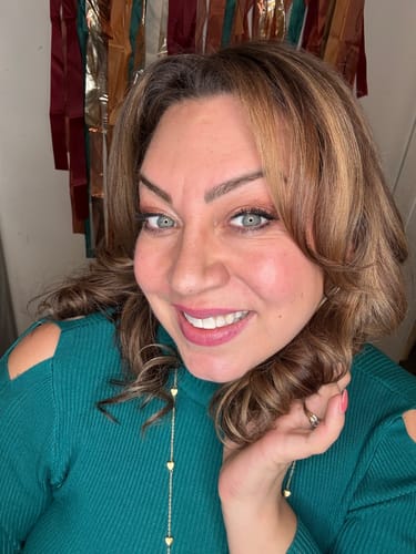 Reviewer with glowing skin smiles after using the HYDRATION face serum.
