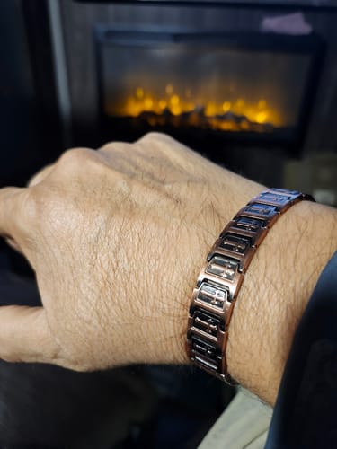 Customer wearing the Templar Cross Copper Bracelet on their wrist, showing the detailed etched links.