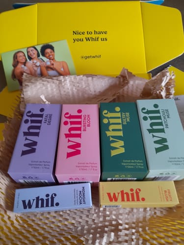 Customer's unboxed Mystery Gift showing a collection of colorful Whif perfume boxes inside a yellow shipping box.