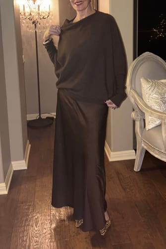 Customer wearing the elegant Camilla Bias Satin Skirt in espresso brown with a matching knit sweater.