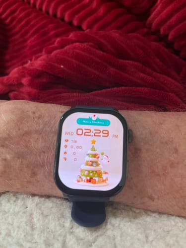 Customer's Gard Pro Health Smartwatch 3 on their wrist, showing a colorful Christmas-themed watch face with health stats.