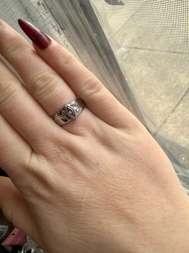 Reviewer wearing the silver February Birthstone Ring, showing the central purple stone and engraved band.
