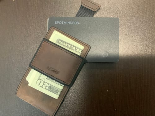 Reviewer's SPOTMINDERS Tracking Card shown next to a brown wallet, demonstrating its slim size.