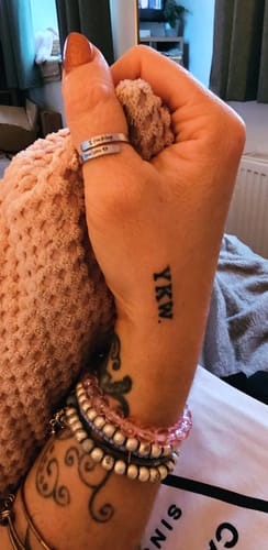 Close-up of a reviewer's hand wearing the adjustable I F♡cking Love You Ring on their thumb.