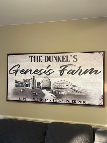 Customer's large Custom Farmhouse Sign hanging on a wall, featuring a black and white illustration of their farm.