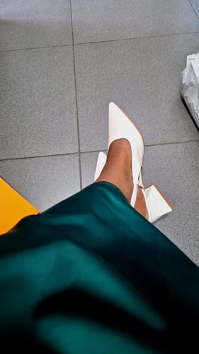 A reviewer wears the white Pointed Toe Slingback Block Heel, seen from above.