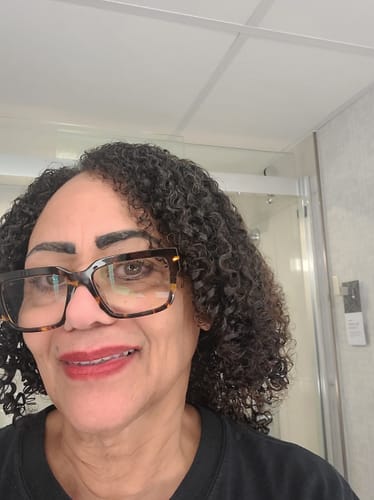 Reviewer with defined, curly hair after using the SET Gel-To-Foam Styling Mousse.