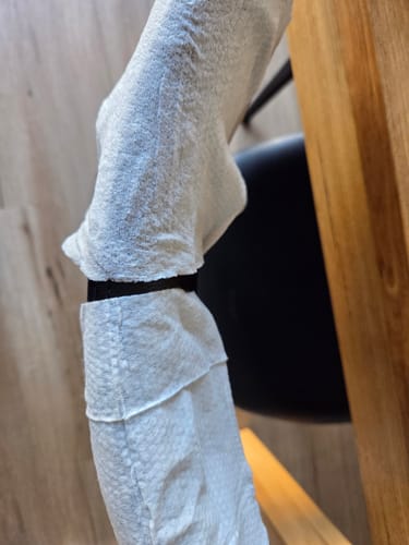 Reviewer compares the thick old Probiotic Baby Wipe to the new, thinner version stretched over an object.