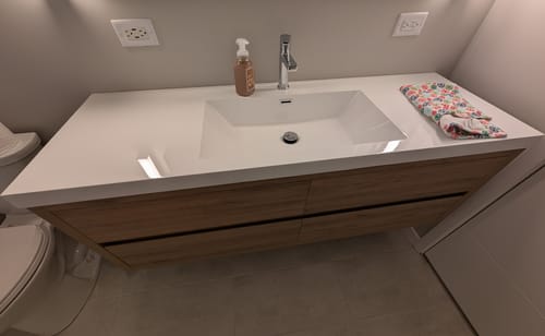 Reviewer's installed Saggia Floating Vanity in a white oak finish with its single, centered sink.