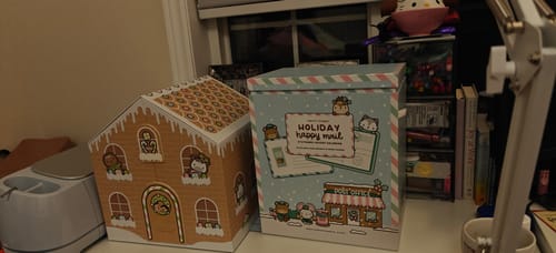 Customer's Gingerbread Advent Calendar and Holiday Happy Mail Advent Calendar from the bundle on a desk.