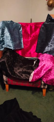 Customer's colorful crushed velvet upholstery fabric samples draped over an armchair.