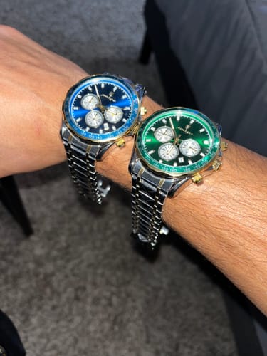 Reviewer showing two Lucky Fours® Chronometer watches on their wrist, one with a blue face and one with a green face.