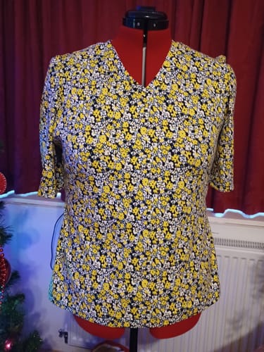 Reviewer's completed v-neck T-shirt made from the Yellow Flowers Cotton Jersey Fabric, shown on a red dress form.