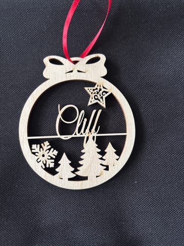 Reviewer's personalized birch wood Christmas ornament with the name 'Cliff' featuring a large swirl on the 'C'.