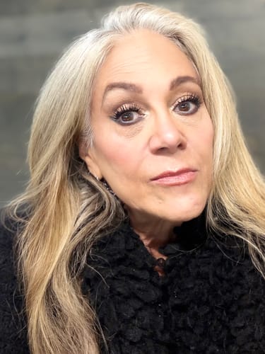 Reviewer in a close-up photo showing off her dark, full lashes.