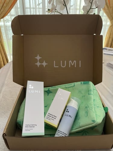 Customer's Cactus Calming Milk Cleanser box sits in a package with a serum, moisturizer, and a green cosmetics bag.