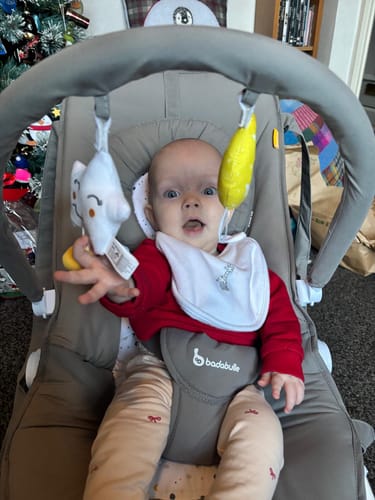 Customer's personal photo of a baby in a bouncer, submitted with their review.