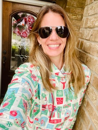 Reviewer smiling outdoors while wearing the festive 'A Jolly Happy Soul' Performance Hoodie.