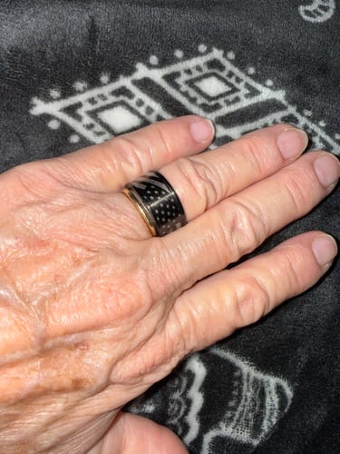 Customer's hand wearing the black and gold Don't Tread On Me Ring, showing the American flag design.