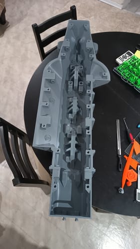 A customer's large, intricate model part printed with the grey Budget PLA Filament, shown on a black table.