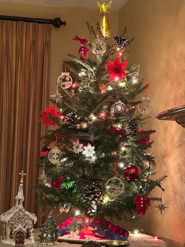 Customer's festive Christmas tree featuring several wooden Nativity Ornaments.
