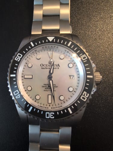 Customer's close-up of the Oceaneva Deep Marine Explorer II watch, showing the white mother-of-pearl dial and black bezel.