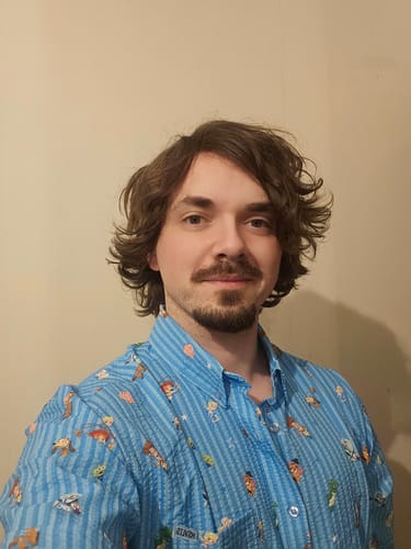 Reviewer wearing the light blue, patterned 'Andy's Playtime Pals' stretch seersucker shirt.