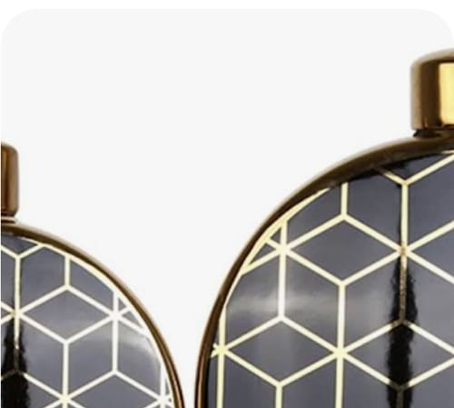 Close-up: Customer's handmade decorative vase, highlighting the dark porcelain and intricate gold geometric pattern.