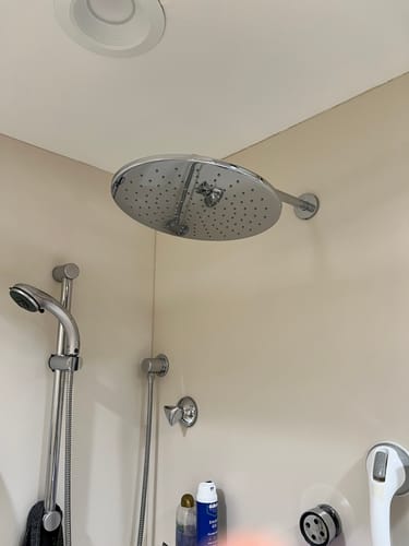 Customer's large, chrome 12 Inch Rain Shower Head installed in the corner of a shower.